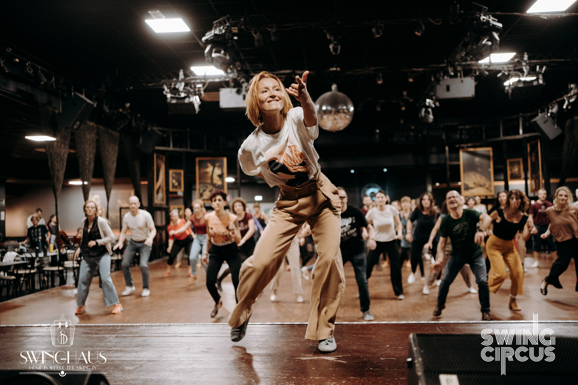 Solo jazz teacher leading a lively dance class, students moving together with energy and joy
