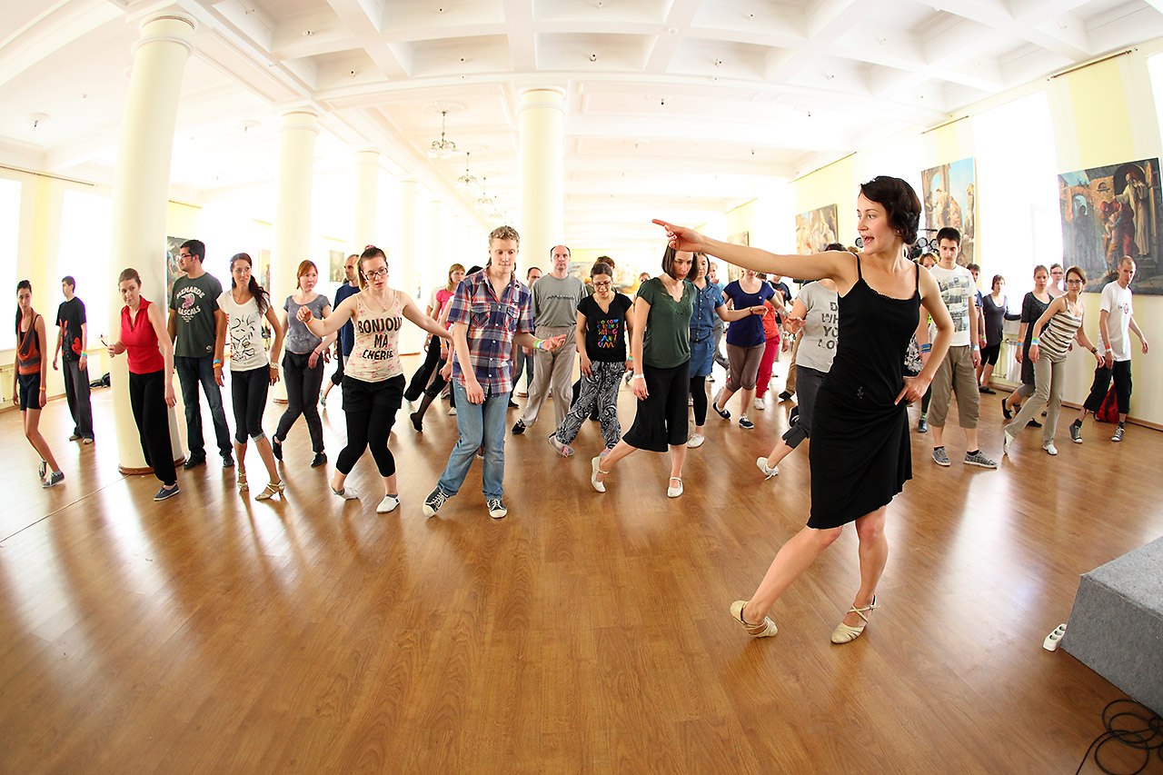Ksenia guiding a group of students through a jazz step
